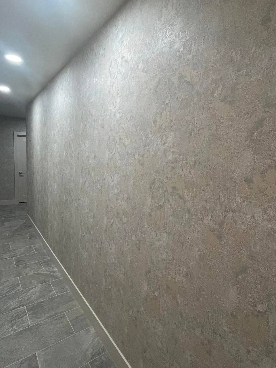 Wallpaper installation on large wall with seamless pattern alignment