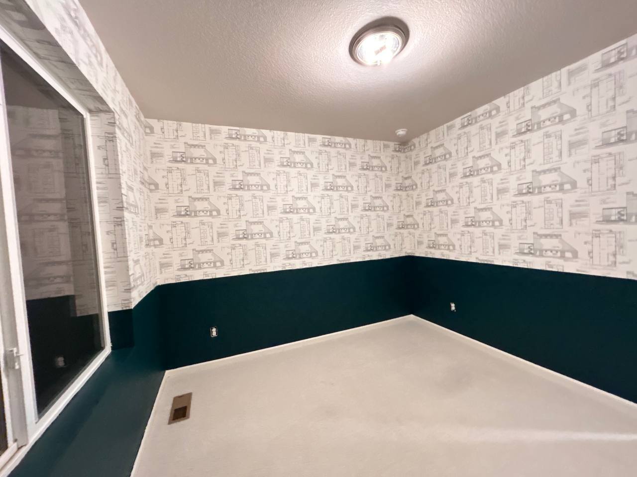 Wallpaper installation with botanical pattern in bedroom