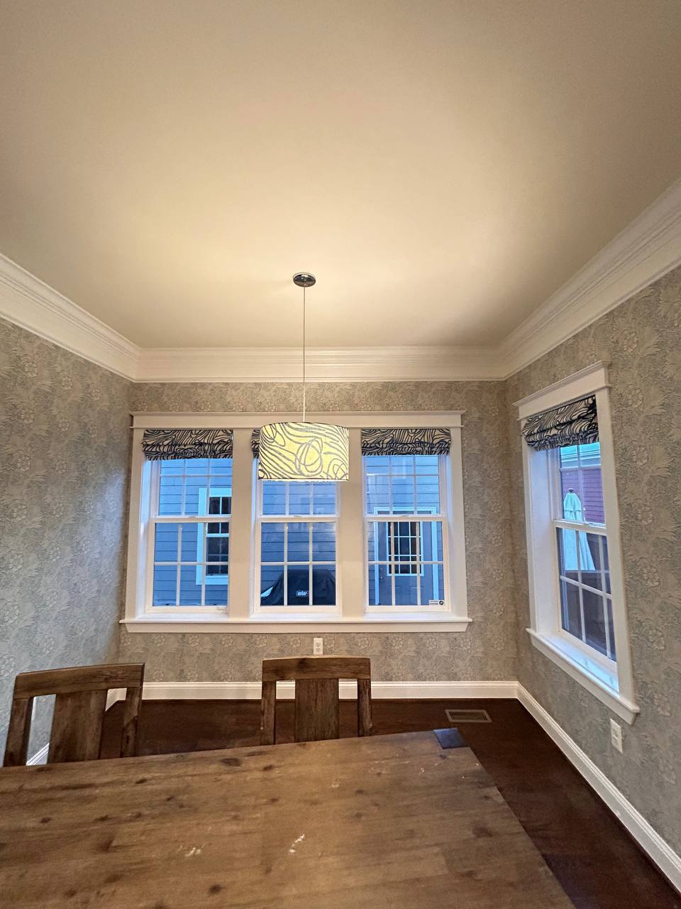 Elegant wallpaper installed with precision on tall wall