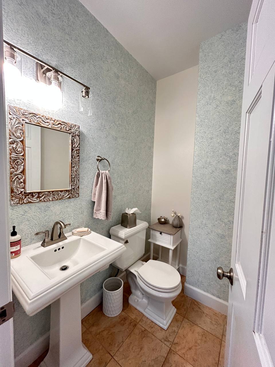 Designer wallpaper installation on feature wall